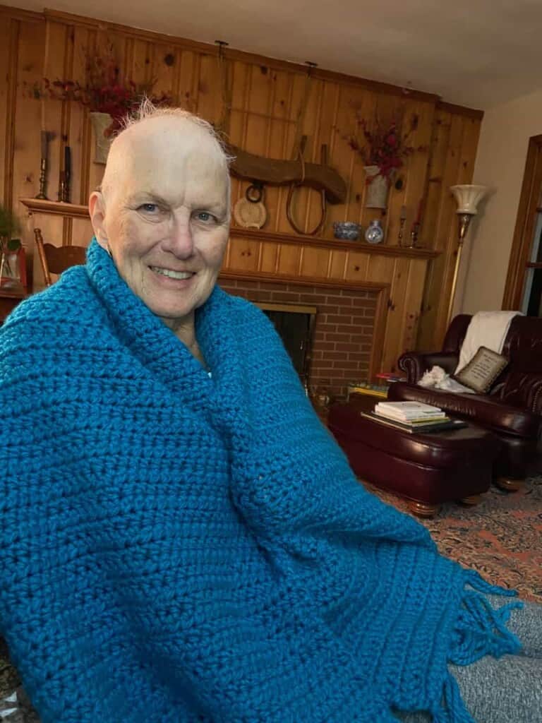 Beth Purcell with a blanket given to her during her cancer treatments